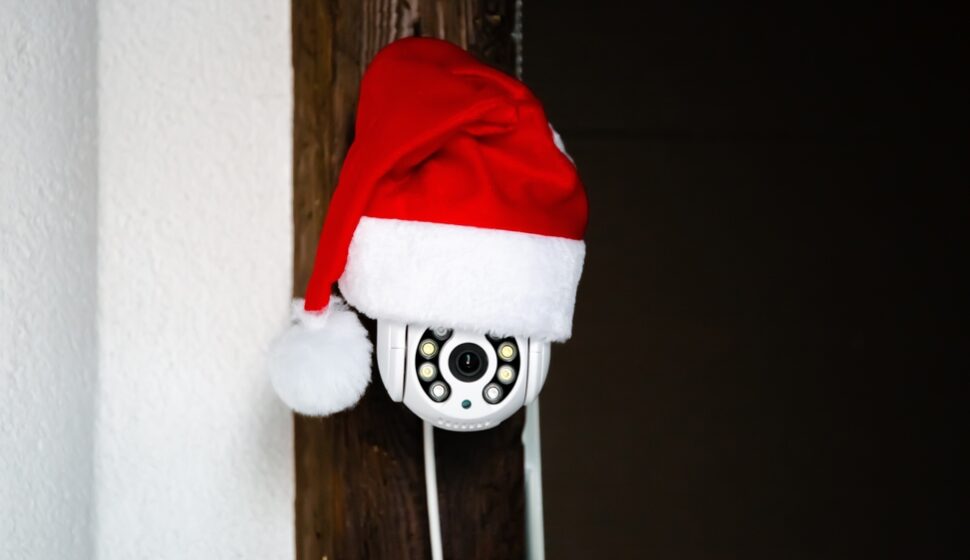 White,cctv,camera,in,red,santa,claus,hat.,outdoor,video