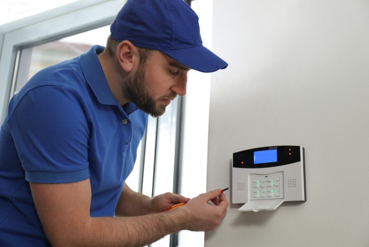 Technician Setting Up Access Control System